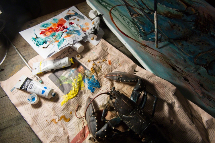 Catherine Forshall painting lobster, lobster on Financial Times, tubes of paint